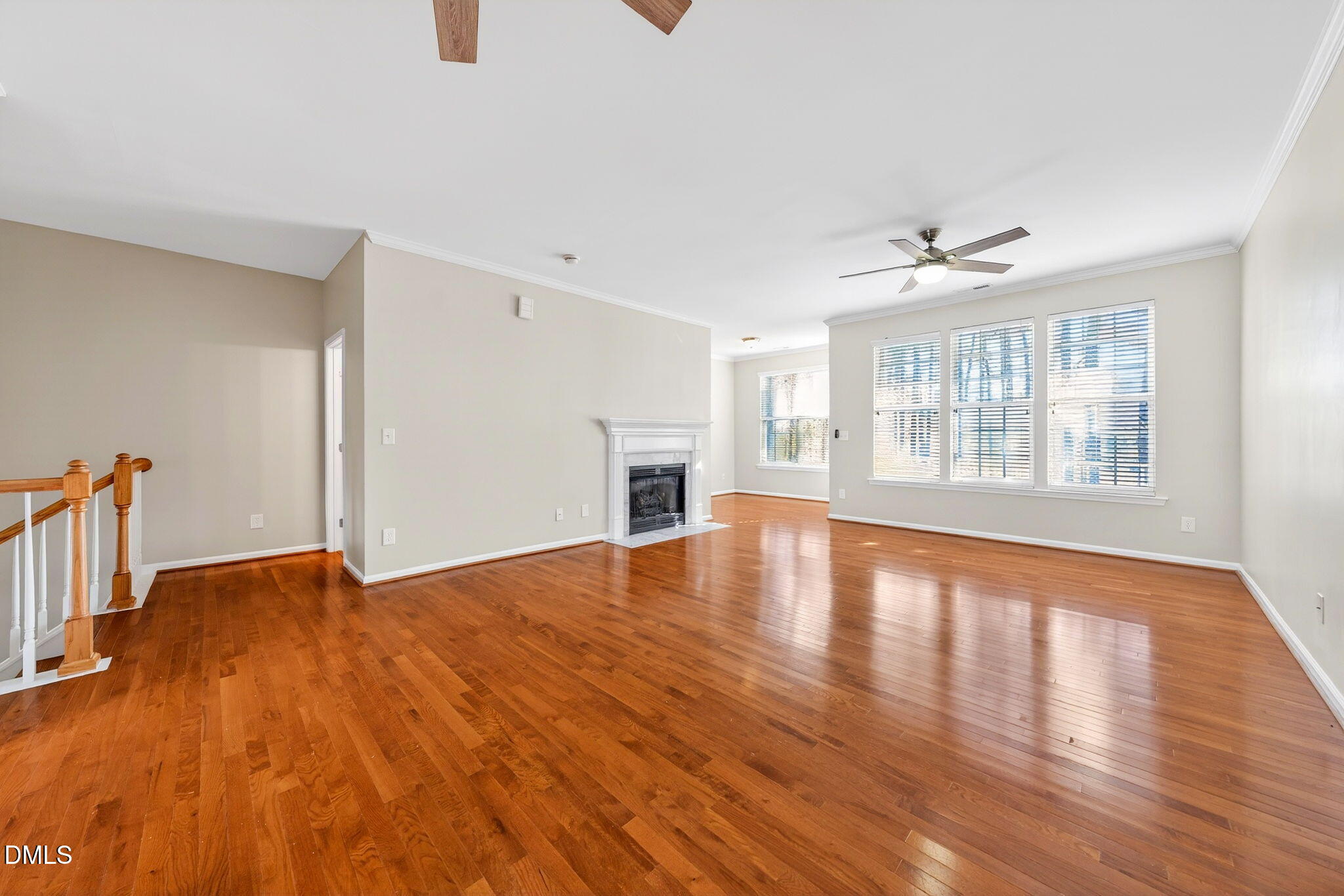 4523 Pale Moss Drive Raleigh, NC 27606 - Photo 10 of 42 a view of empty room with wooden floor and fireplace