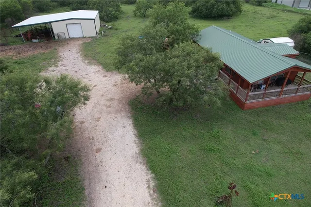 a view of a wooden house with a yard