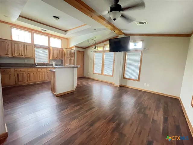 a view of a kitchen with a sink and wooden floor