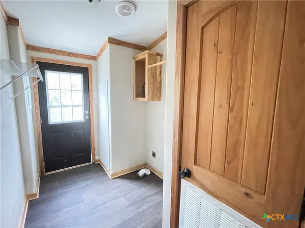 a view of an entryway with wooden floor