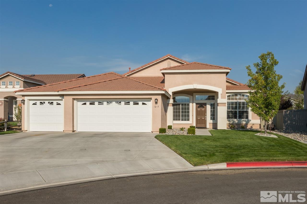 1215 El Monte Court Reno, NV 89521 - Photo 1 of 1 a front view of a building with a yard and garage