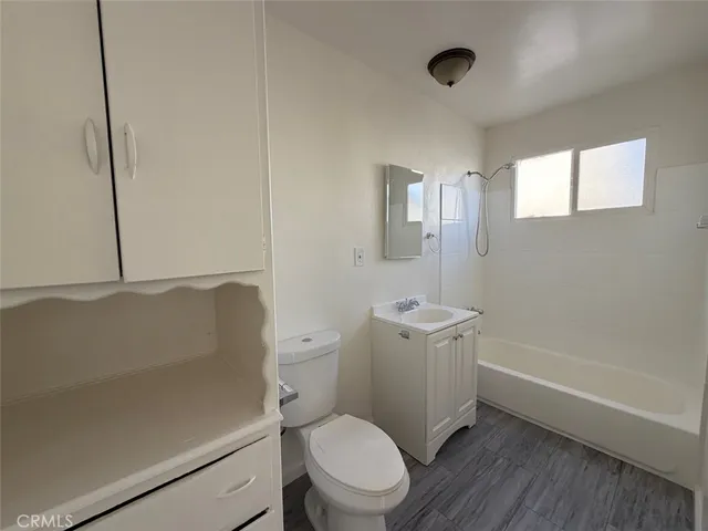 a bathroom with a toilet a sink and bathtub