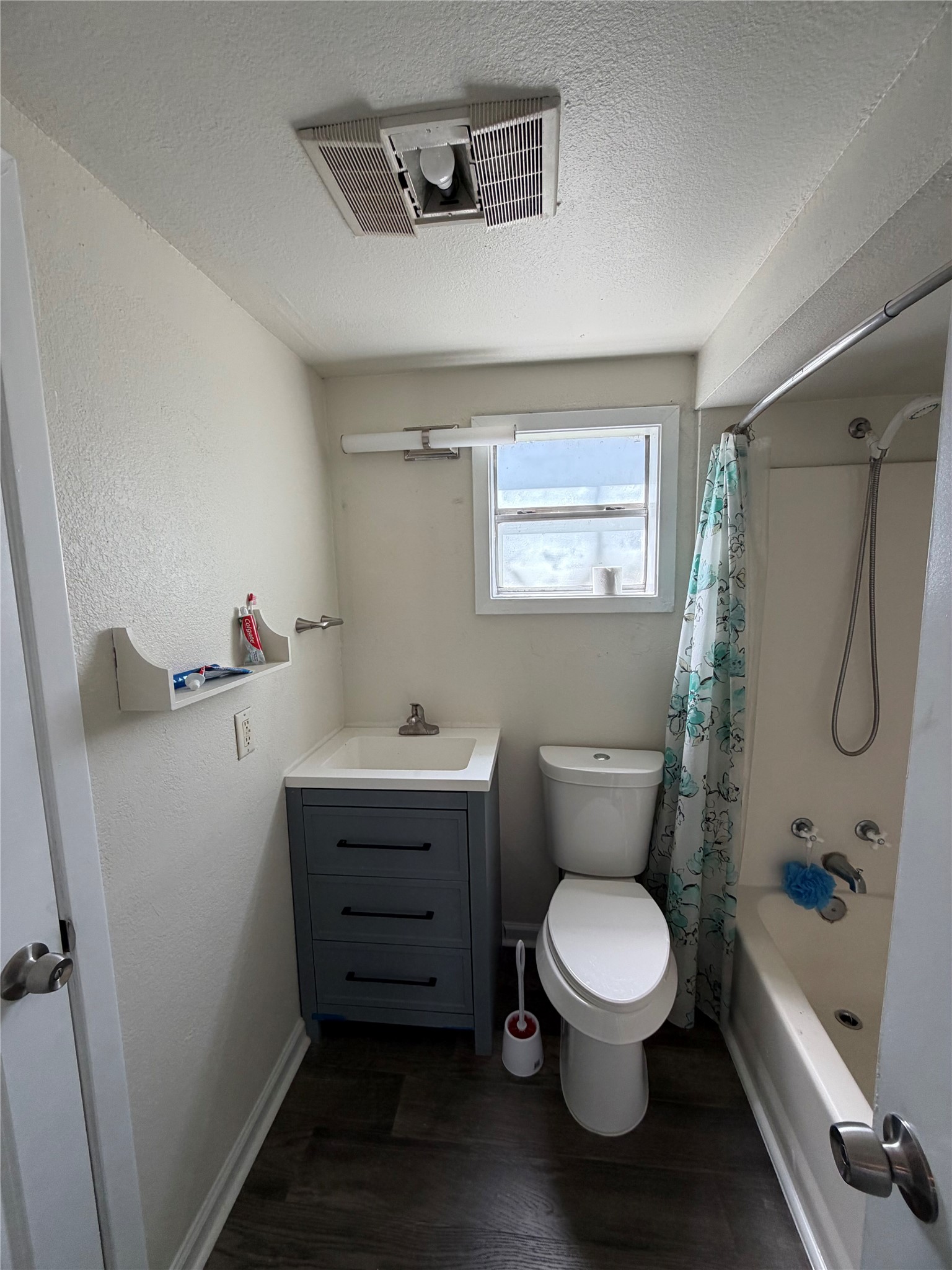 507 Swanee Drive, Unit B Austin, TX 78752 - Photo 8 of 8 a bathroom with a toilet sink and shower