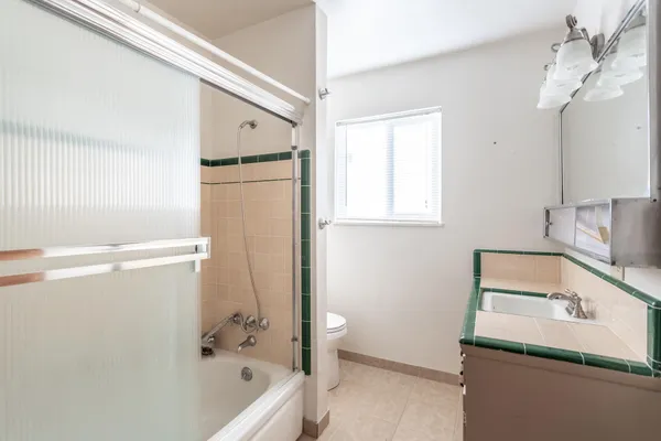 a bathroom with a tub a sink and a shower