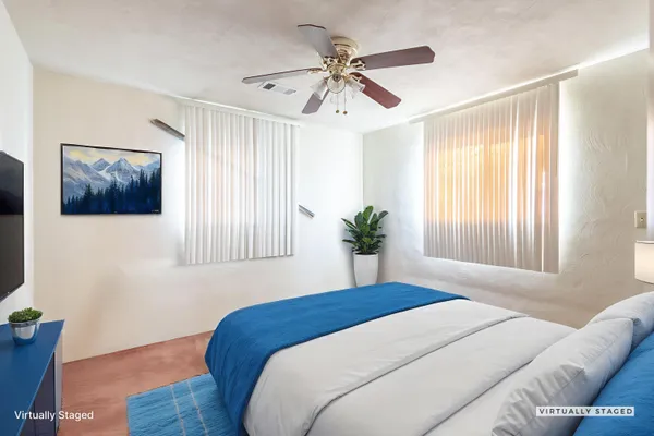 a bedroom with a bed and a window