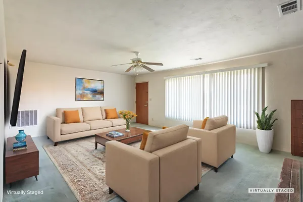 a living room with furniture and a potted plant