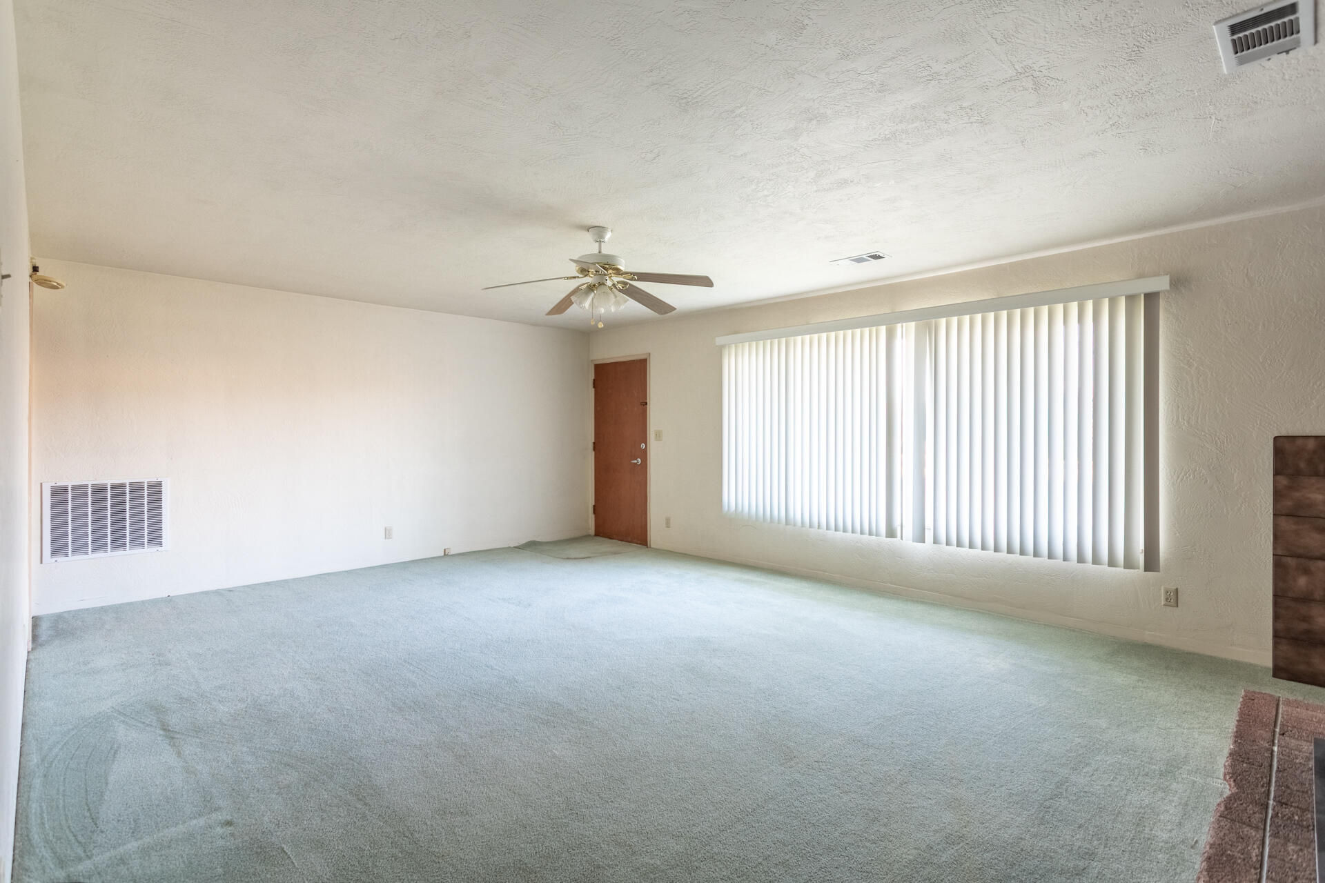 2381 South Bonnyview Road Redding, CA 96001 - Photo 5 of 26 an empty room with windows and chandelier fan