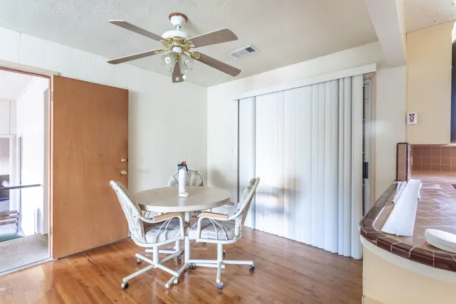 a view of a dining room with furniture and a window