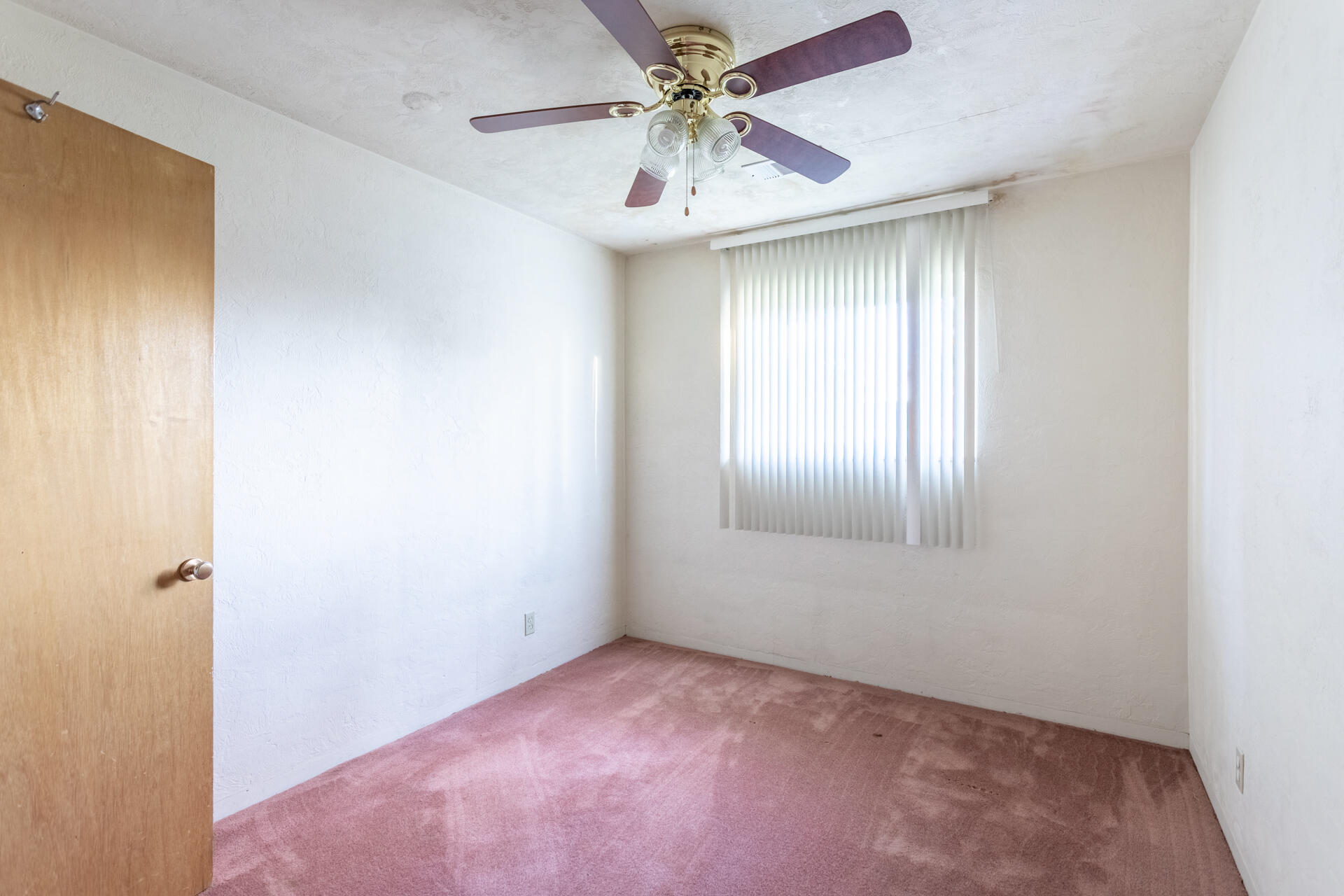 2381 South Bonnyview Road Redding, CA 96001 - Photo 10 of 26 an empty room with a window and a chandelier fan