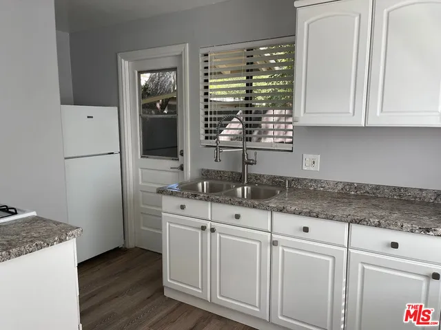 a stove top oven sitting inside of a kitchen