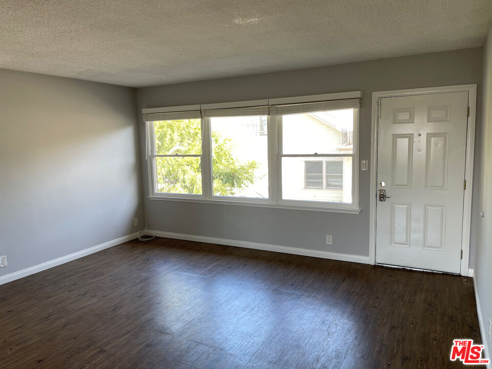 137 North Myrtle Avenue Monrovia, CA 91016 - Photo 16 of 41 a view of an empty room with wooden floor and a window