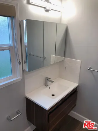 a kitchen with a refrigerator and a sink