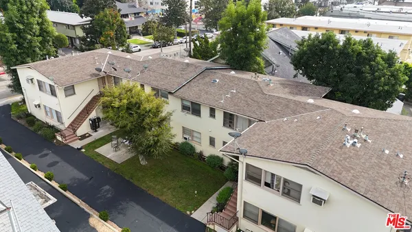 an aerial view of residential houses with city view