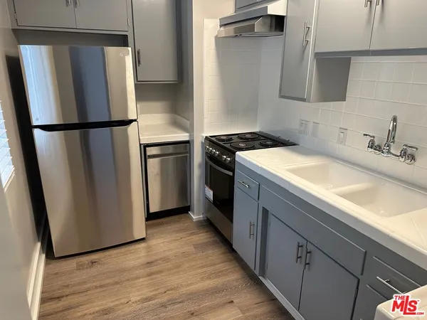 a kitchen with a refrigerator sink and stove