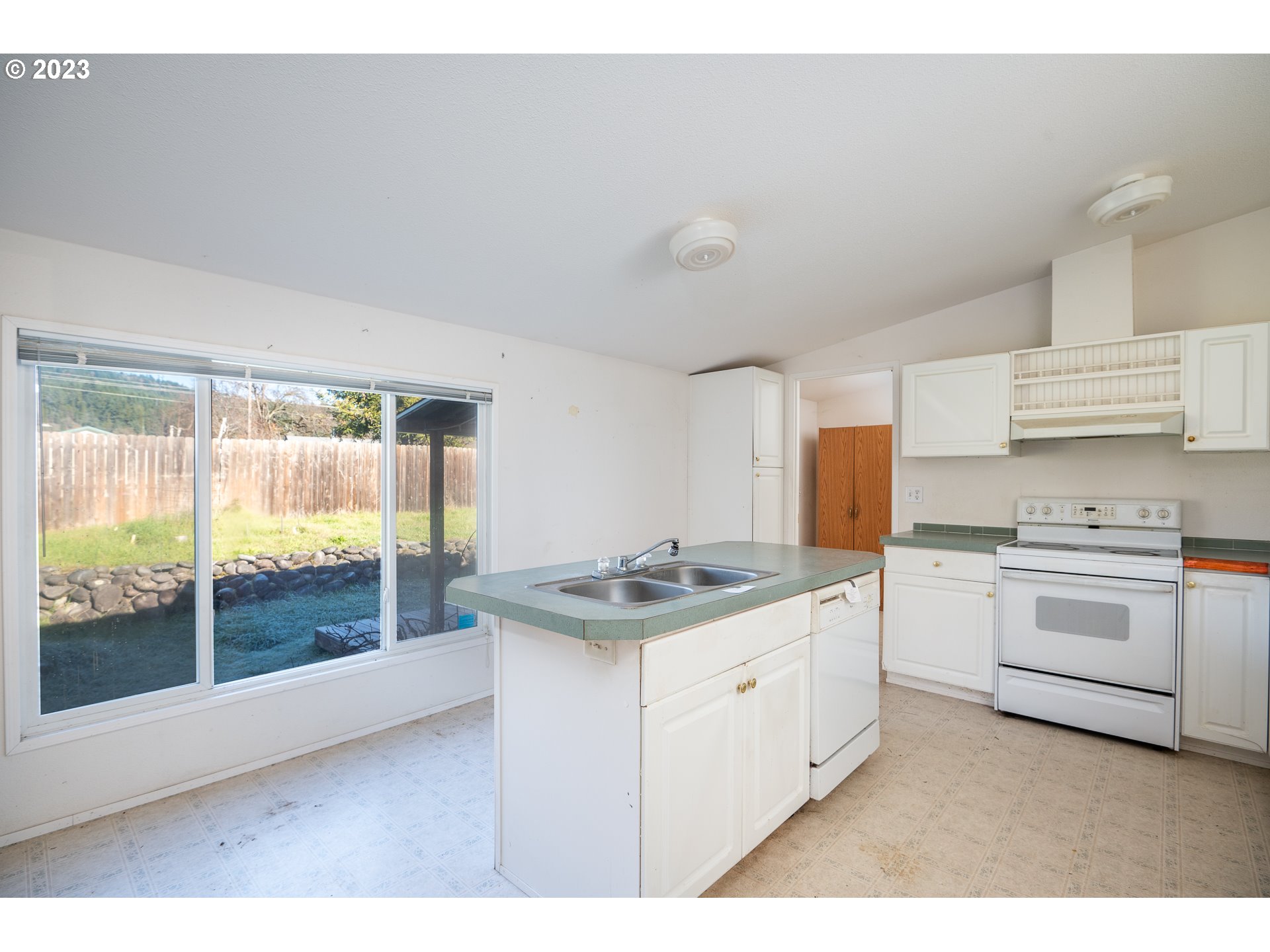 76367 Klohn Road Oakridge, OR 97463 - Photo 21 of 42 a kitchen with a sink stove and cabinets