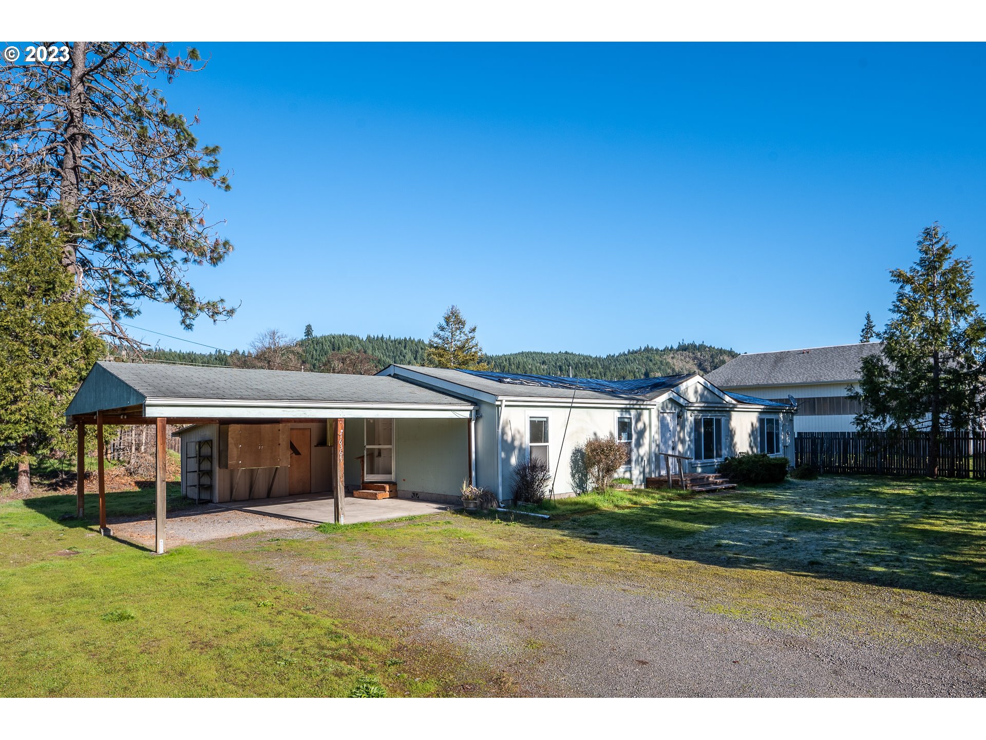 76367 Klohn Road Oakridge, OR 97463 - Photo 5 of 42 a front view of a house with a garden