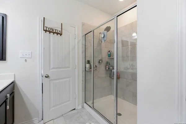 a bathroom with a glass shower door