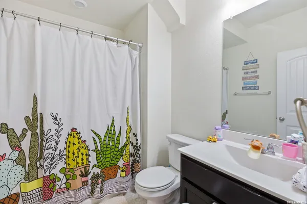 a bathroom with a sink a toilet and a mirror