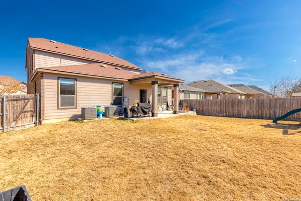 a swimming pool with outdoor seating and yard