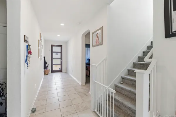 a view of a hallway with wooden floor and entryway
