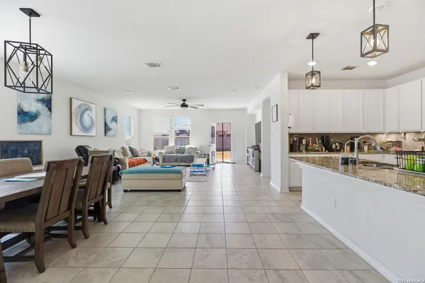 a open kitchen with cabinets a counter and appliances