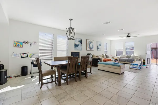 a living room with furniture and a dining table