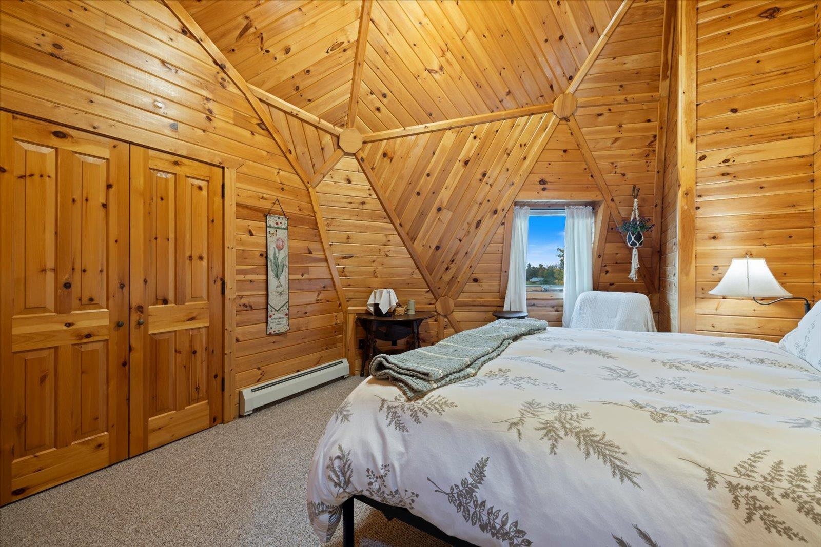 3581 County Line Road Sturgeon Lake, MN 55783 - Photo 50 of 85 Carpeted bedroom featuring wood walls, vaulted ceiling, a baseboard radiator, and wooden ceiling