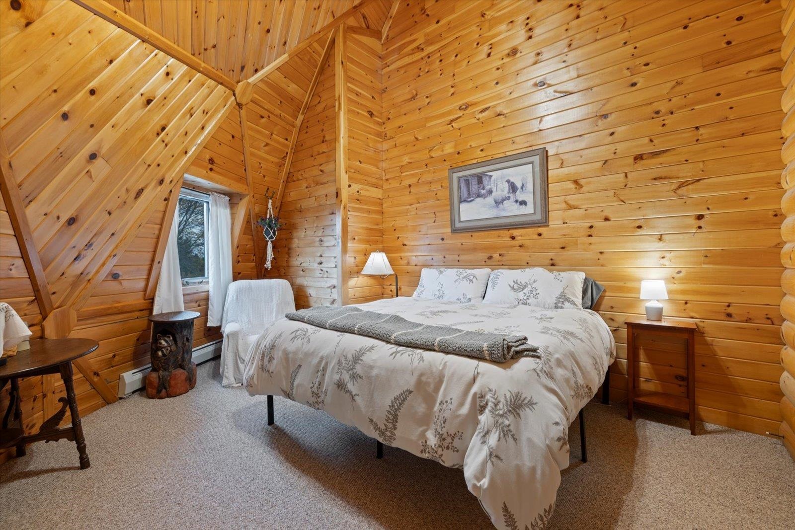 3581 County Line Road Sturgeon Lake, MN 55783 - Photo 51 of 85 Carpeted bedroom with wood walls, high vaulted ceiling, and a baseboard heating unit