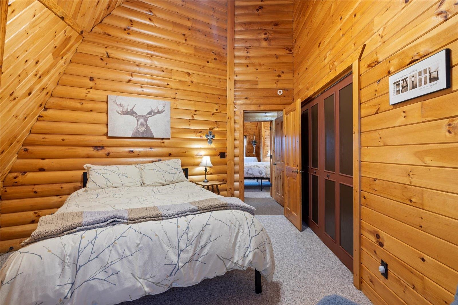 3581 County Line Road Sturgeon Lake, MN 55783 - Photo 53 of 85 Bedroom featuring a closet, light colored carpet, and a towering ceiling
