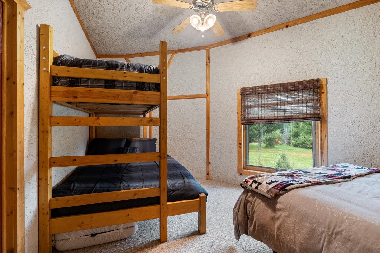 3581 County Line Road Sturgeon Lake, MN 55783 - Photo 61 of 85 Carpeted bedroom featuring a textured wall, a ceiling fan, and a textured ceiling