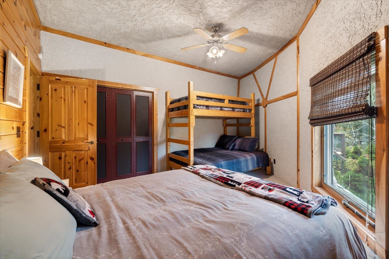 3581 County Line Road Sturgeon Lake, MN 55783 - Photo 62 of 85 Bedroom with ornamental molding, a textured wall, a textured ceiling, a ceiling fan, and a closet