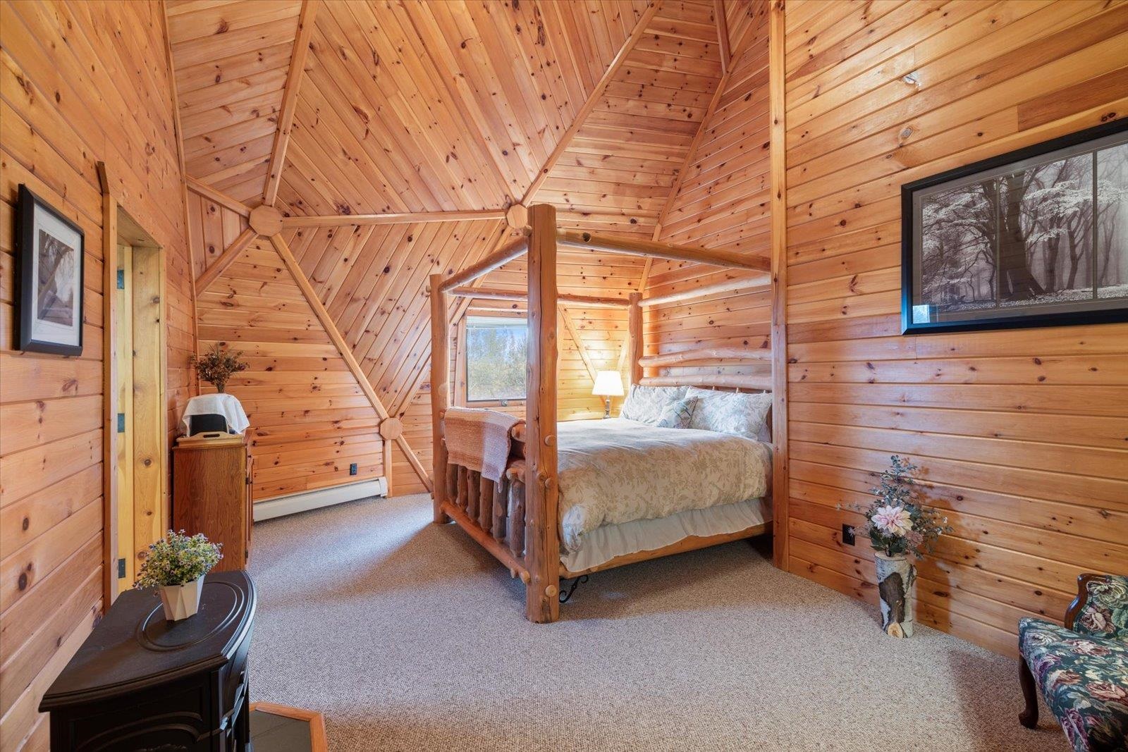 3581 County Line Road Sturgeon Lake, MN 55783 - Photo 63 of 85 Bedroom featuring wooden walls, carpet, a baseboard radiator, vaulted ceiling, and wood ceiling