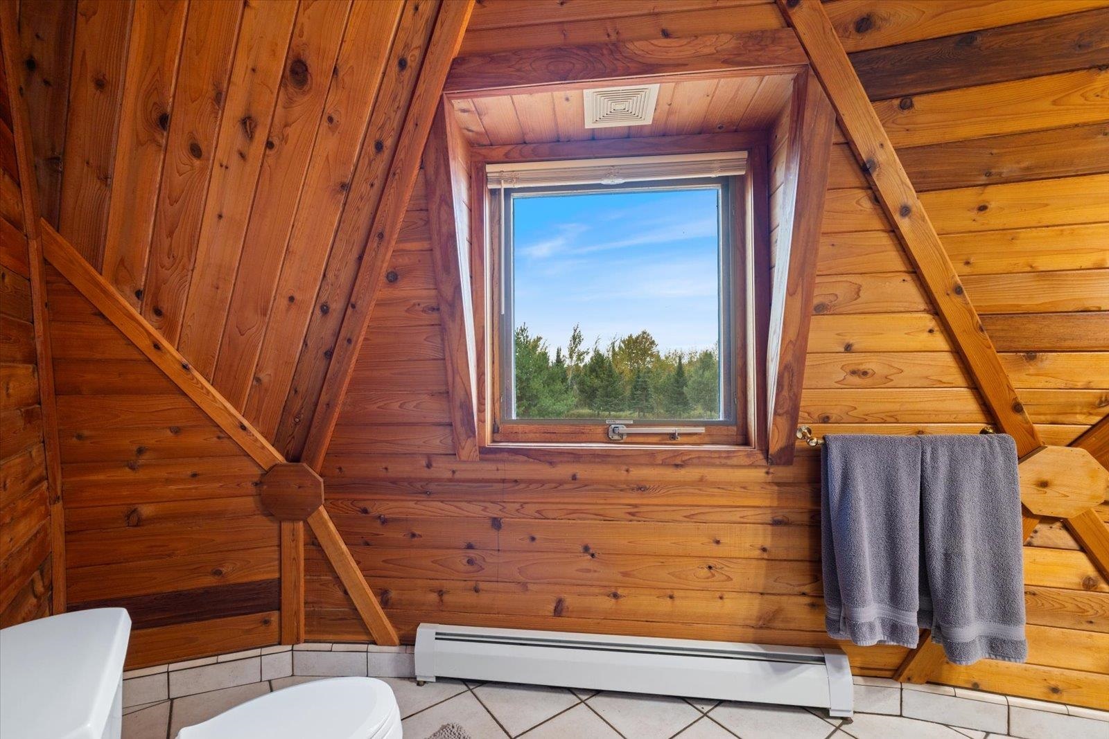 3581 County Line Road Sturgeon Lake, MN 55783 - Photo 74 of 85 Bathroom with a baseboard heating unit, tile patterned flooring, wood walls, and wood ceiling