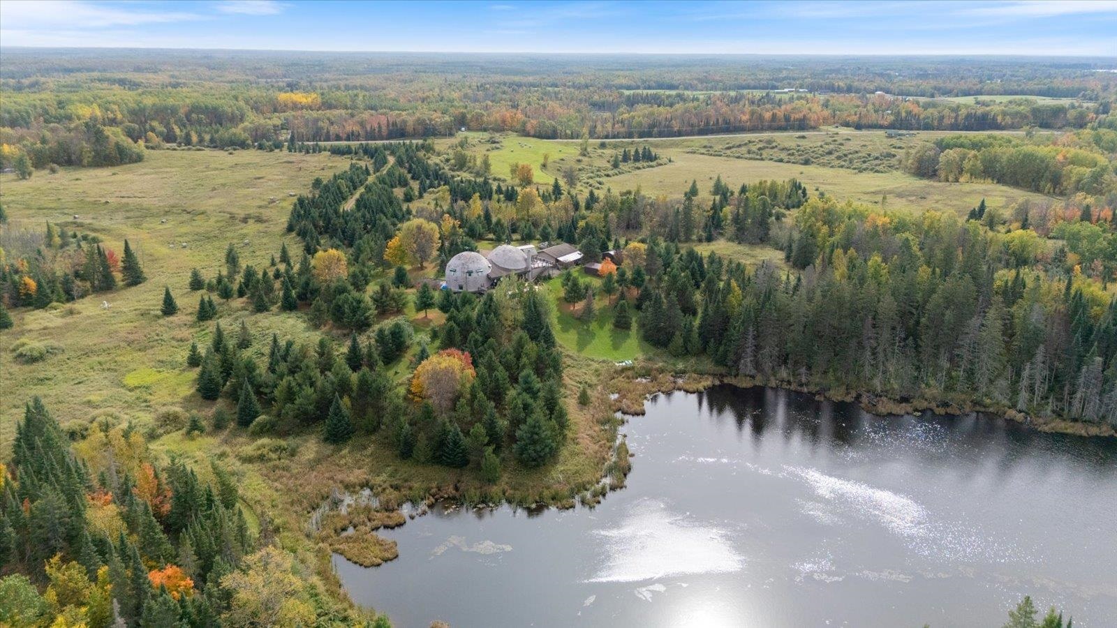3581 County Line Road Sturgeon Lake, MN 55783 - Photo 10 of 85 Aerial view of property and surrounding area with a nearby body of water and a heavily wooded area