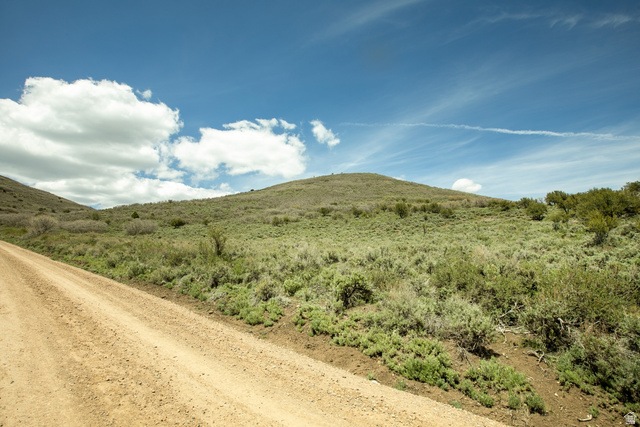 1646 North Miles Holw Road, Unit 29 Kamas, UT 84036 - Photo 21 of 35 Dirt road bordering a grassy hillside with scattered brush