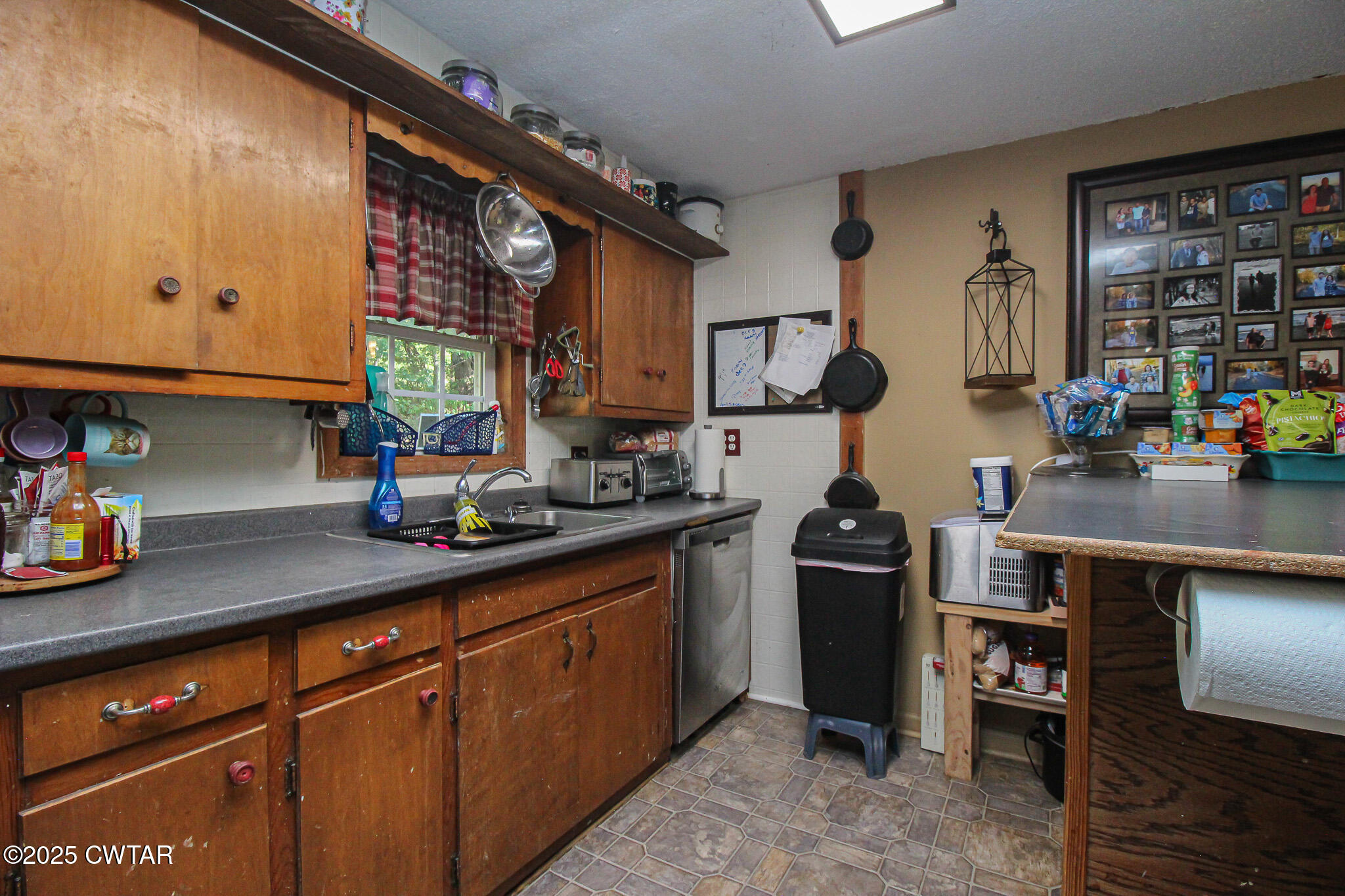 60 Moore Avenue Friendship, TN 38034 - Photo 6 of 14 a kitchen with stainless steel appliances granite countertop a sink dishwasher stove and cabinets