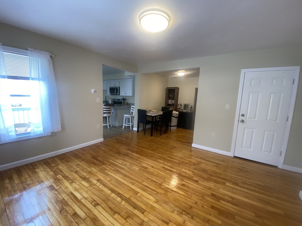 82 Mill Street Worcester, MA 01603 - Photo 12 of 39 a view of kitchen and dining room with wooden floor