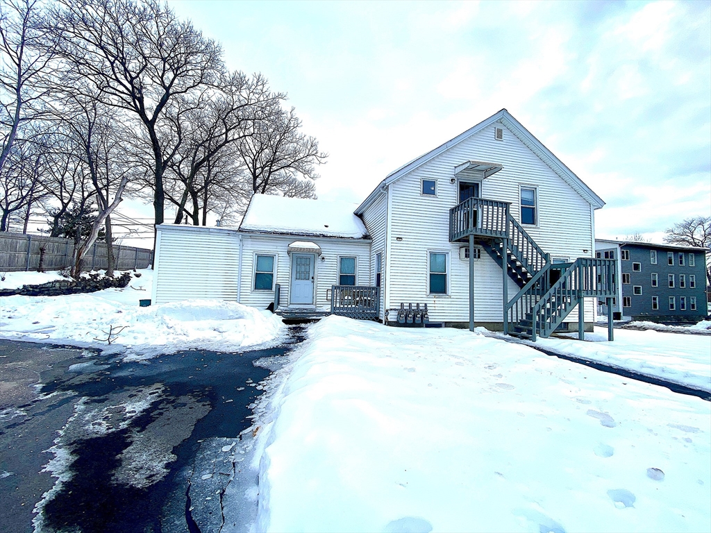 82 Mill Street Worcester, MA 01603 - Photo 2 of 39 a front view of a house with a yard