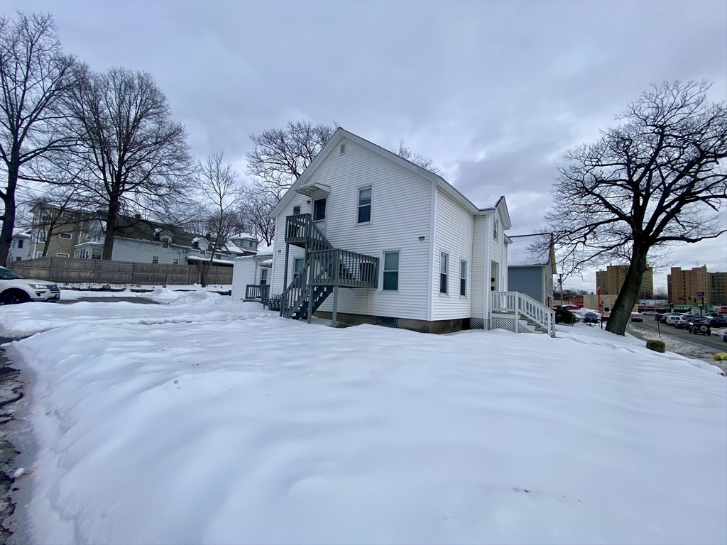 82 Mill Street Worcester, MA 01603 - Photo 37 of 39 a view of a house with a snow in the yard