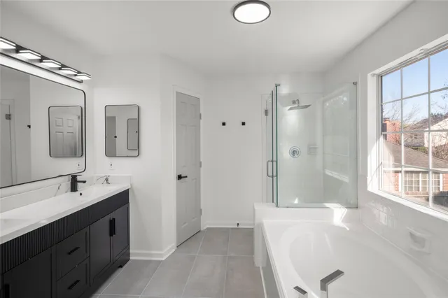 a spacious bathroom with a double vanity sink mirror double and bathtub