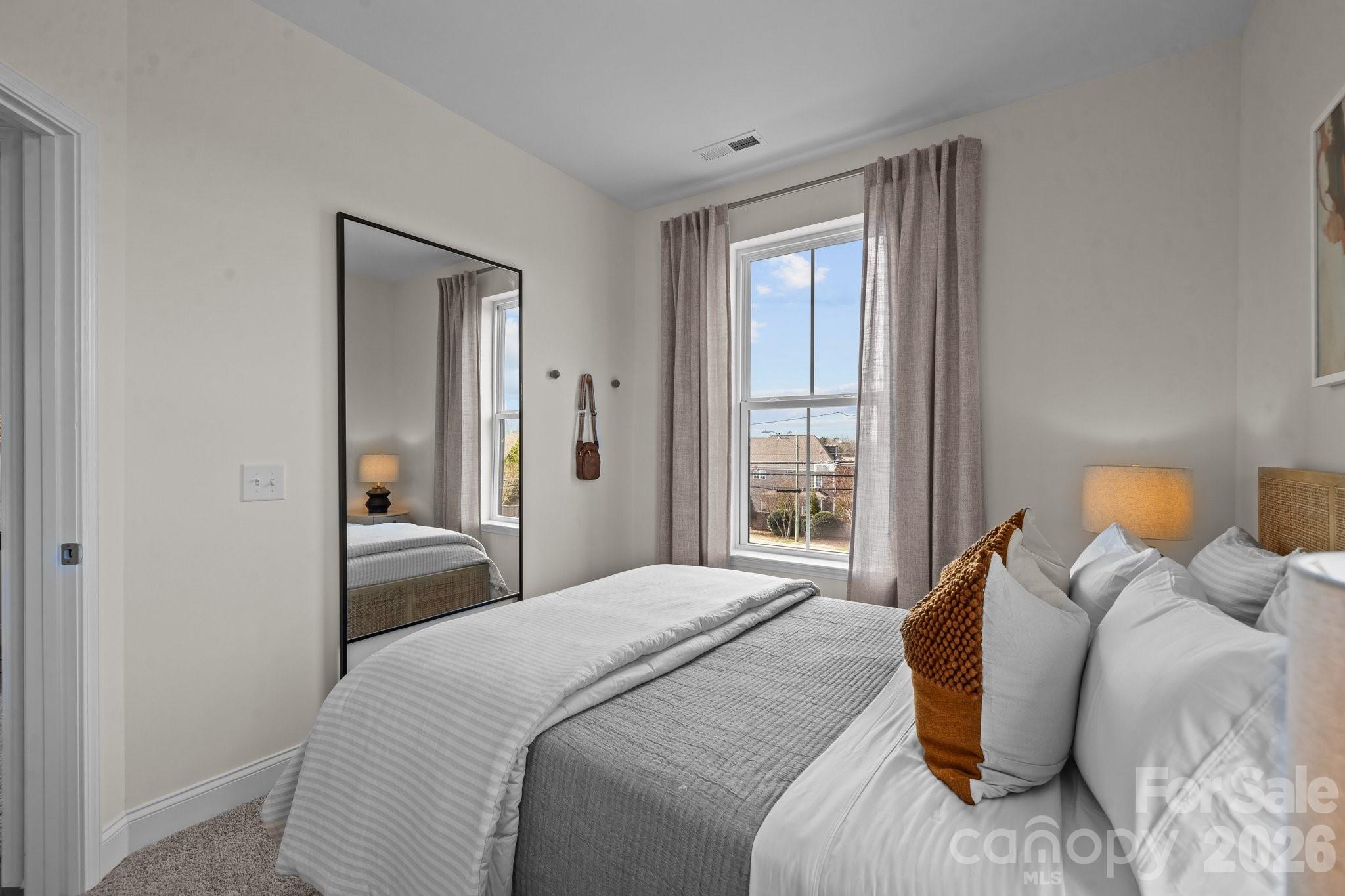 3023 Rozzelles Ferry Road Charlotte, NC 28208 - Photo 19 of 25 a bedroom with a bed and a window