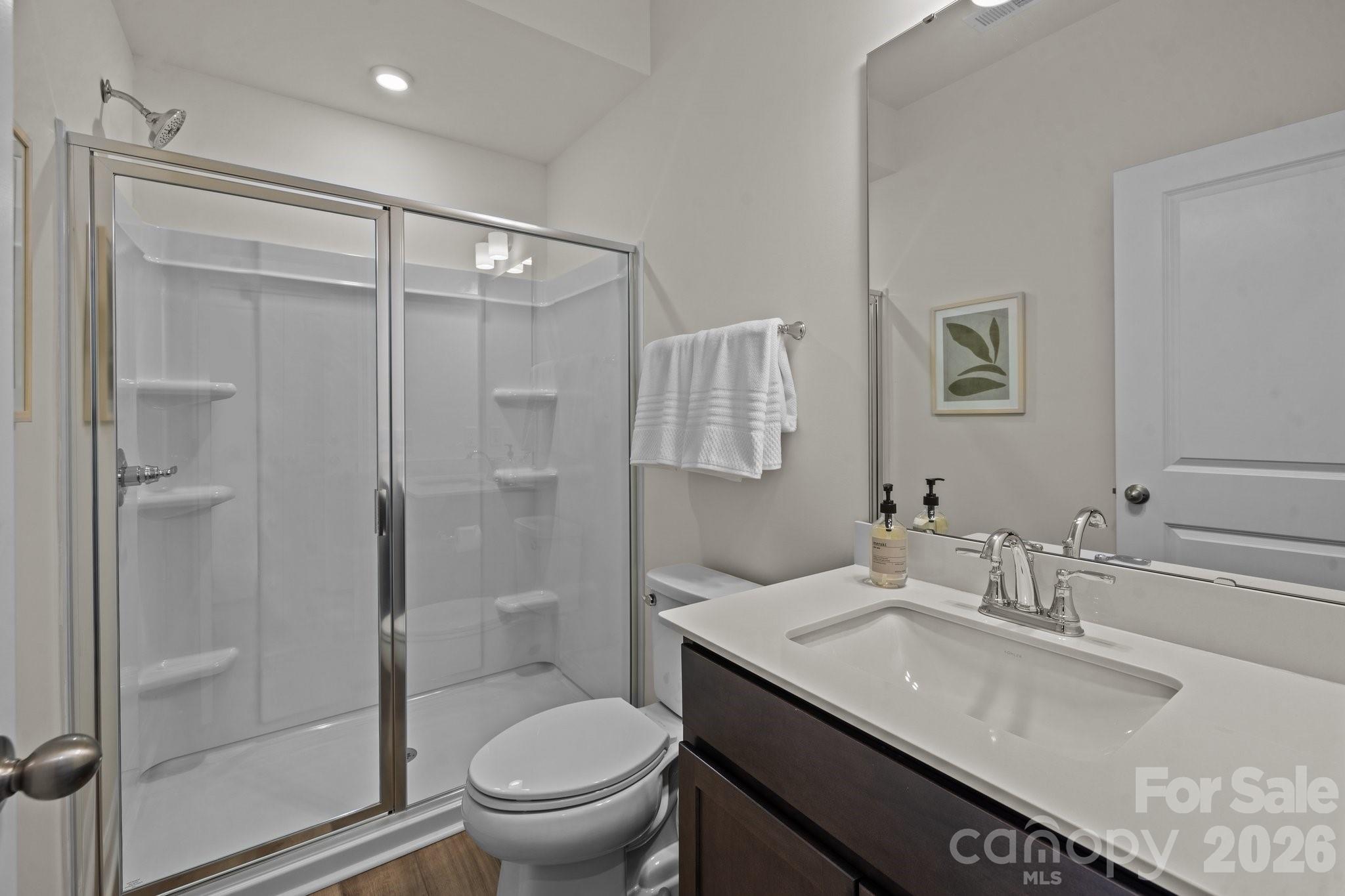 3023 Rozzelles Ferry Road Charlotte, NC 28208 - Photo 5 of 25 a bathroom with a granite countertop sink a toilet and shower