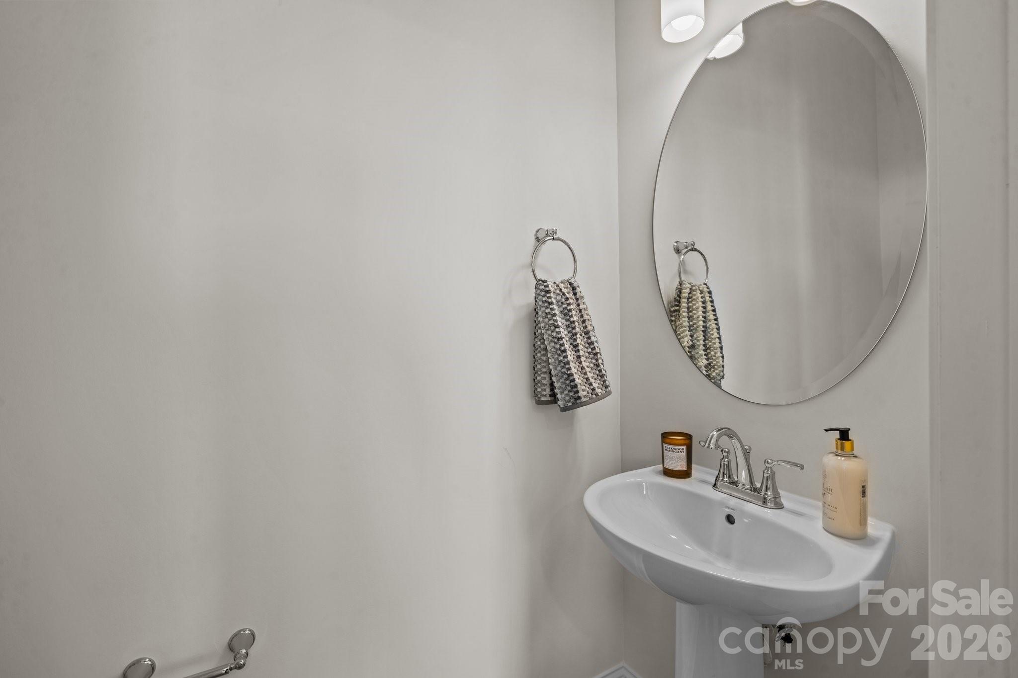 3023 Rozzelles Ferry Road Charlotte, NC 28208 - Photo 9 of 25 a bathroom with a sink and mirror