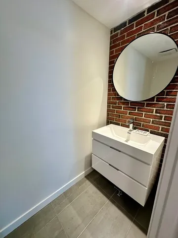 a bathroom with a sink mirror and vanity