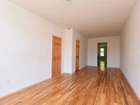 547 83rd Street Brooklyn, NY 11209 - Photo 3 of 12 a view of an empty room with wooden floor