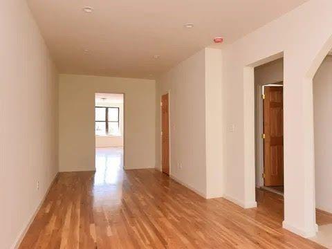 547 83rd Street Brooklyn, NY 11209 - Photo 4 of 12 wooden floor in an empty room with a window