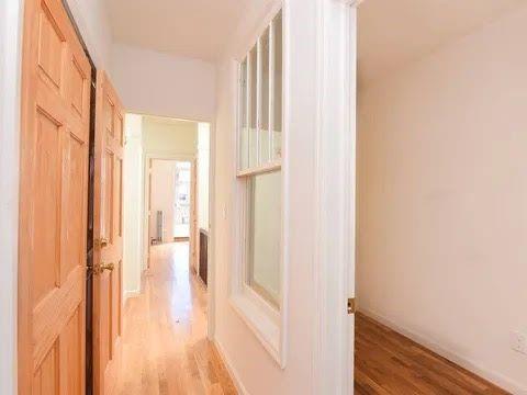 547 83rd Street Brooklyn, NY 11209 - Photo 9 of 12 a view of a hallway with wooden floor and staircase