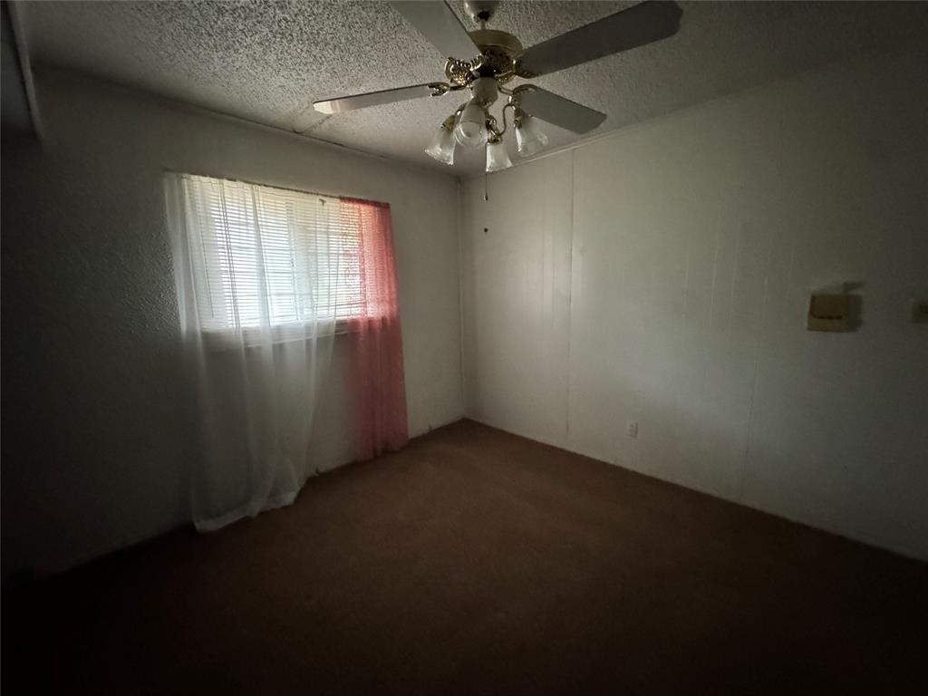 3909 Smothers Road Caney City, TX 75148 - Photo 22 of 35 an empty room with a window and a fan