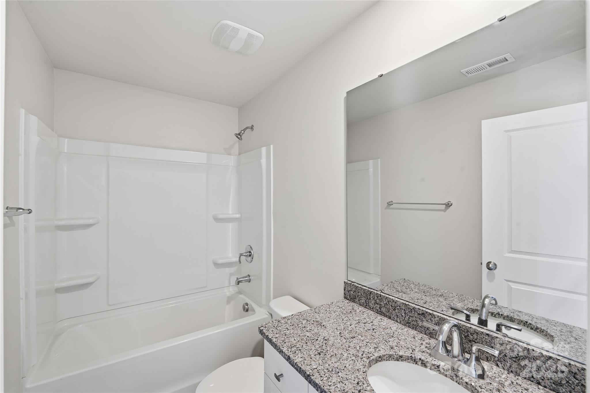 1532 Null Road Lincolnton, NC 28092 - Photo 19 of 32 a bathroom with a granite countertop tub sink and mirror