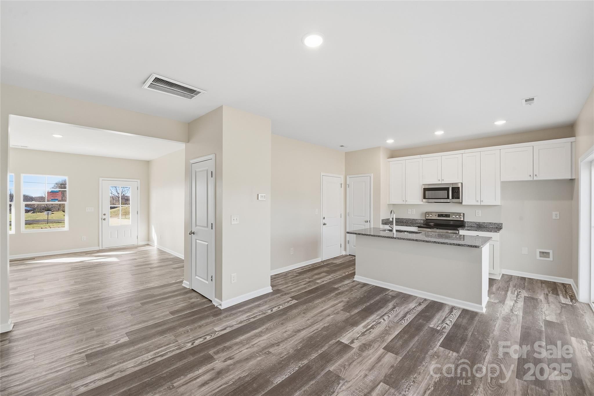 1532 Null Road Lincolnton, NC 28092 - Photo 22 of 32 a kitchen with stainless steel appliances granite countertop a stove top oven a sink and a refrigerator